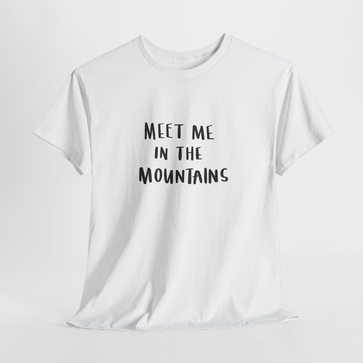Mountain t-shirt with hand-lettered text 'Meet me in the mountains'
