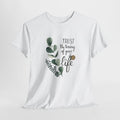 Inspirational t-shirt with a watercolor eucalyptus sprig and 'Trust the timing of your life' script